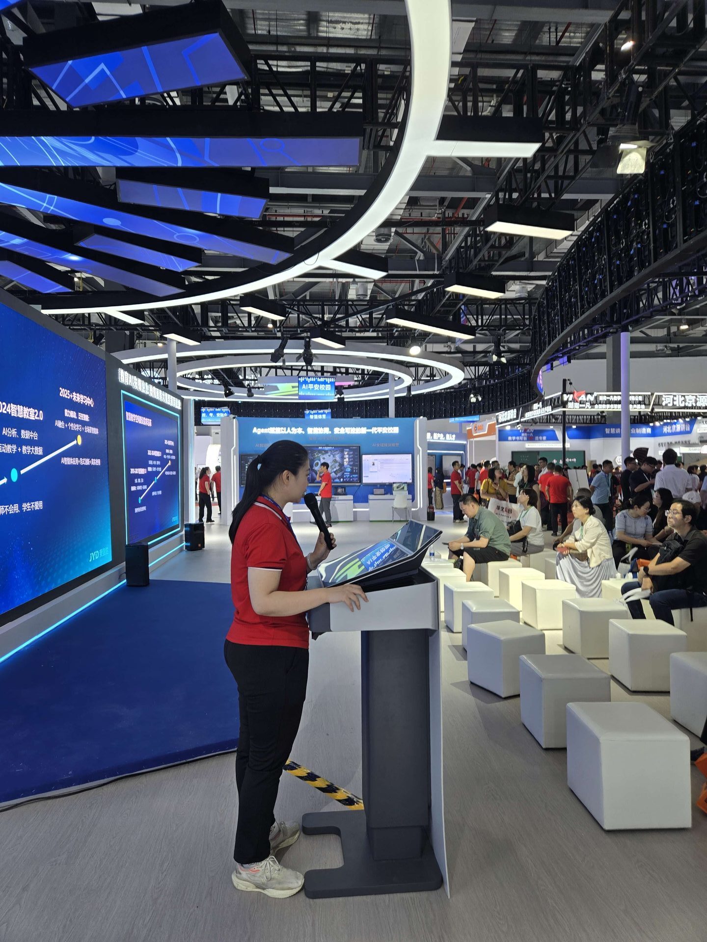 Host demonstrating YFD320 education podium display screen