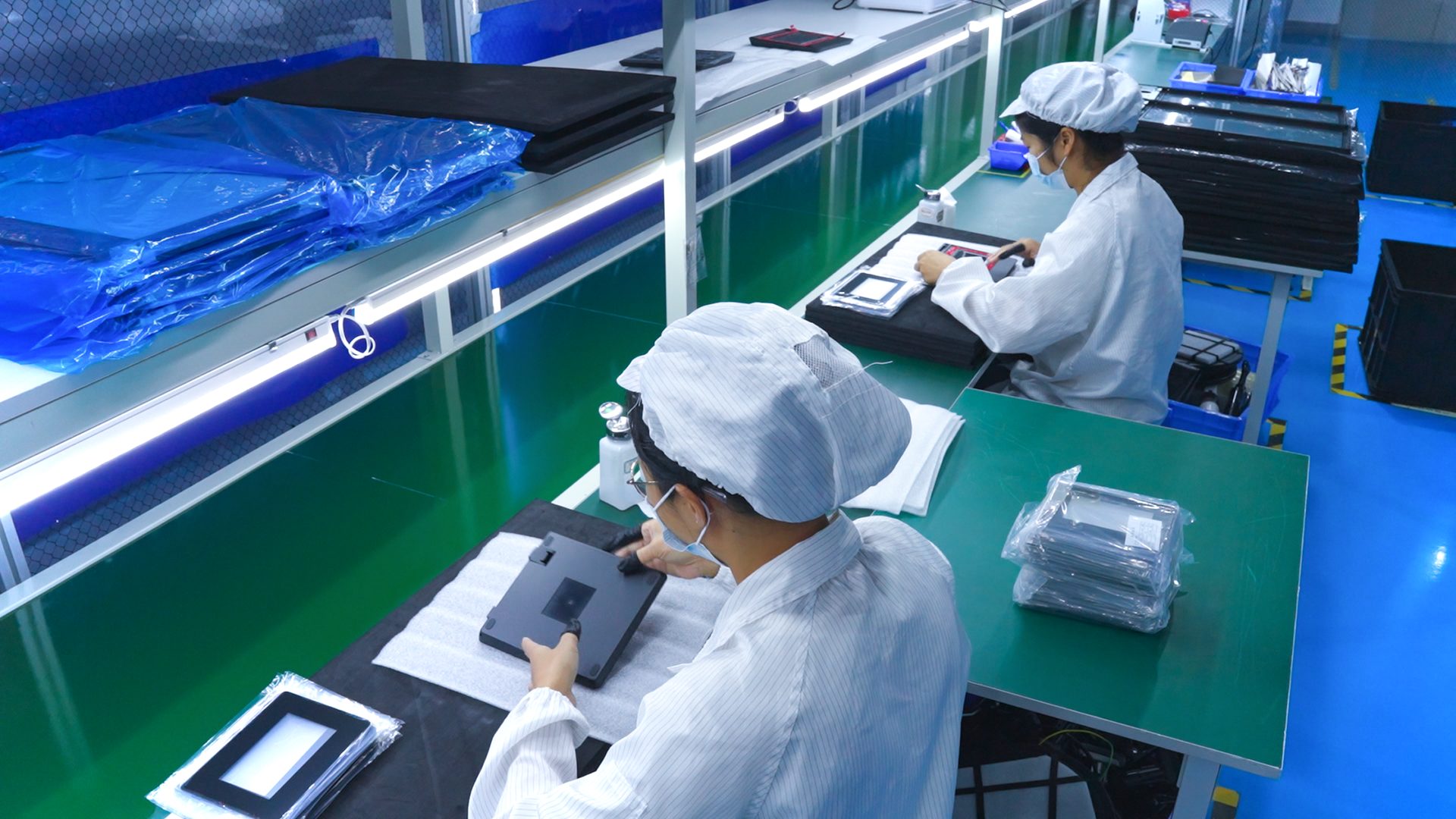 Workers operating in Haveways laminating workshop